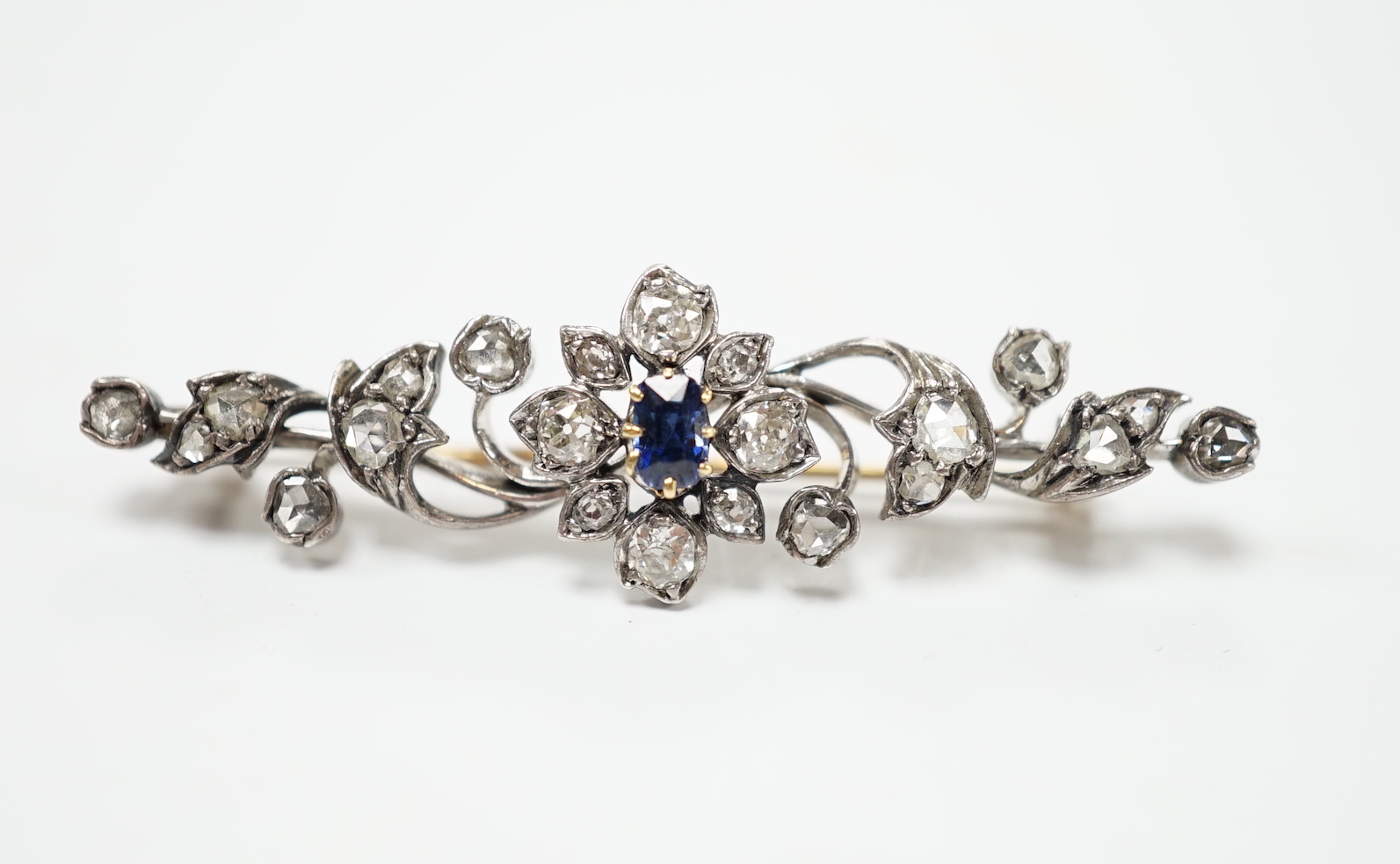 A late Victorian yellow and white metal, sapphire, old and rose cut diamond cluster set foliate brooch, 47mm, gross weight 4.3 grams.